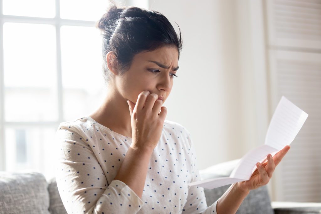 Anxious young woman get unpleasant news in letter